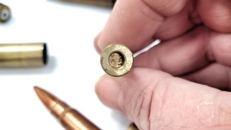 Mass produced ammunition sold cheaply. This cartridge has no flash hole.